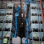 Genie Z40/23 NRJ articulating boom good reach to ceiling in warehouse with two side by side working in narrow warehouse aisle