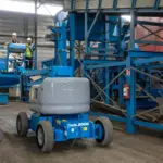 Genie Z45/25 JDC articulating boom working outdoor in narrow aisle in warehouse